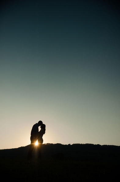 Engaged couple photographed against sunset near Chattanooga, TN by Dotson Studios.